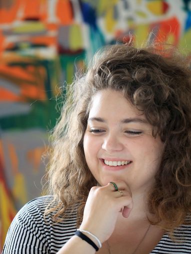 Smiling woman with hand under her chin