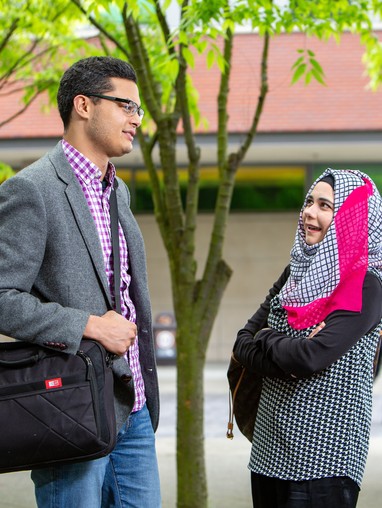 A man and woman standing next to each other.