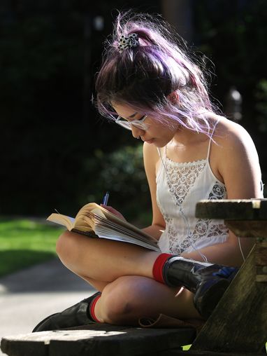 student reading on campus