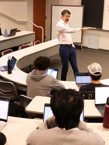 A teacher teaching in a full classroom