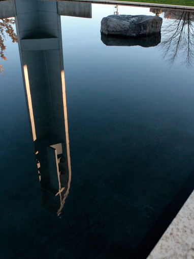 A body of water with a watchtower reflection.