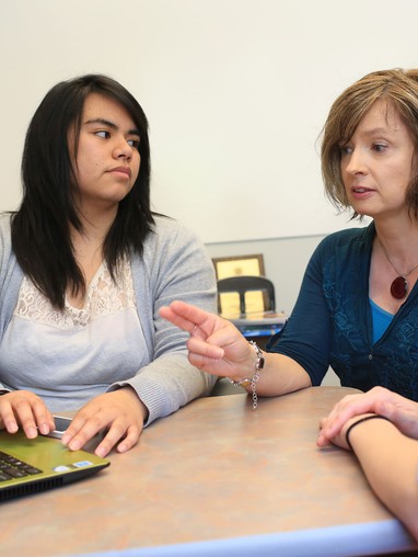 A group of students and a professor studying 