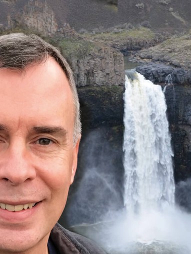 Portrait of Chris Longston with a waterfall in the background