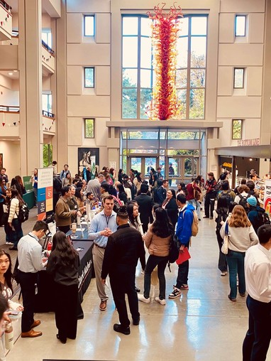 A crowd of people meeting in an atrium