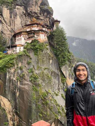 Man in front of temple in Bhutanese mountains