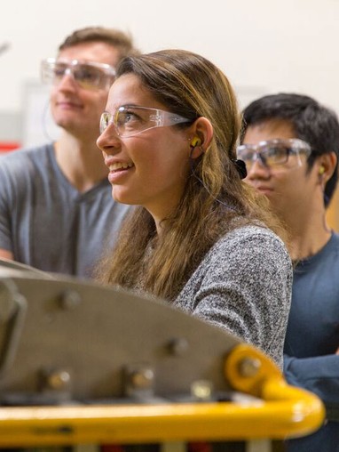 Students working with mechanical equipment