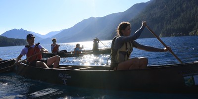 Students at a lake paddling