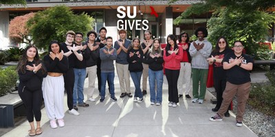 Su Gives with students