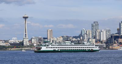A Washington State Ferry Cruises Past the Space Needle
