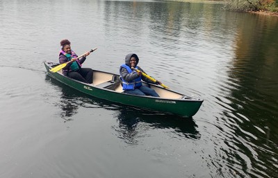 Two students paddling a kayak on the lake