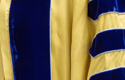 Close-up of yellow and blue academic robes