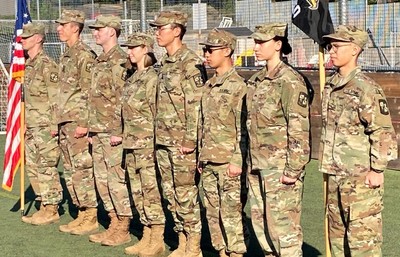 A group of soldiers standing on a soccer field.