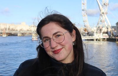 Woman smiling with London Eye behind