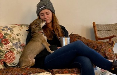 Lexi sitting on couch with her dog