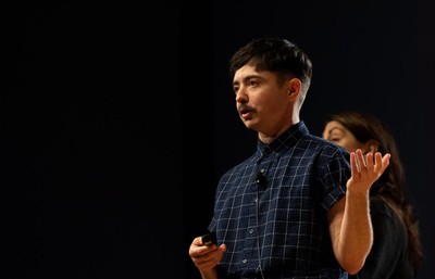 Dean Spade speaking on a stage.