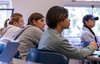 A group of people sitting in a classroom.