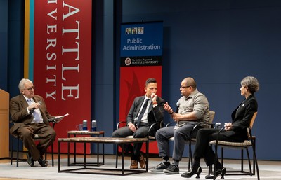 Joni Balter and Larry Hubbell interview Congressman Adam Smith and Dr. Umair A. Shah on stage