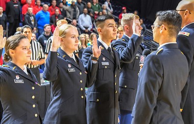A group of people in military uniforms standing in front of a crowd.