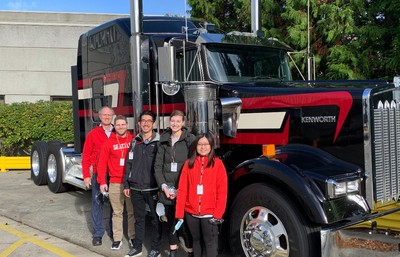 Students standing in front of Kenworth truck cab