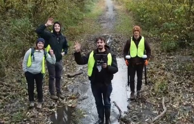 Civil engineering Student team in safety gear standing in a watershed