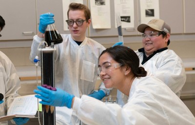 Student group working in a lab environment to test water quality