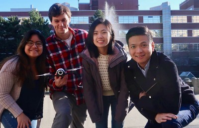 Student group posing in front of fountain in Seattle University Quad