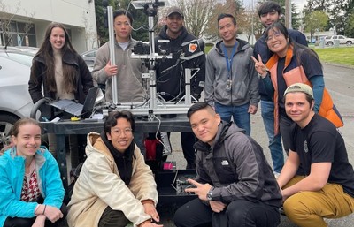 Electrical and Mechanical Engineering students posing with Amazon Data Center cart