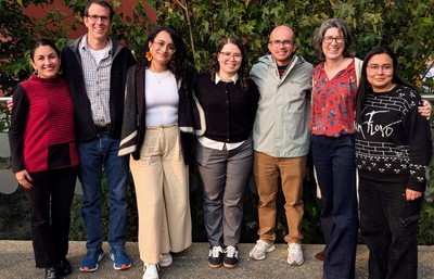 A group of researchers standing outside smiling