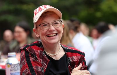Incoming President Maura Mast wearing a Seattle University cap