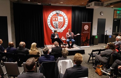 President Eduardo Penalver speaking on stage with Keith Whittington