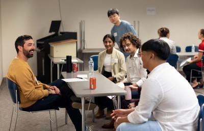 Group of students talking with a alumni mentor