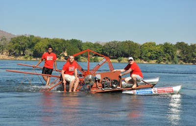 A team of recent graduates and their mentor test a run-of-river electrical generator in the Zambezi River in Zambia.