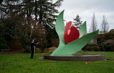 Seattle University's curator of art, Josef Venker, S.J., alongside the impressive sculpture.