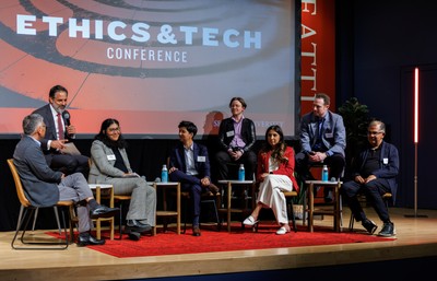A photo of ethics and tech speakers talking on stage