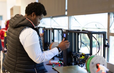 Image of student at a machine at the CCE Change Maker Summit