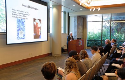 Robin Yates delivers lecture in front of screen