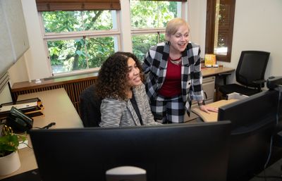 Paige Powers and Laura Heider working at a computer