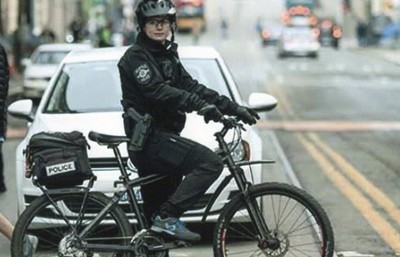 Lexi Brenneman Harris on a bike in police uniform