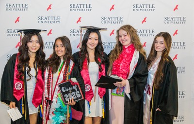 Five Seattle University Class of 2026 Graduates in caps and robes
