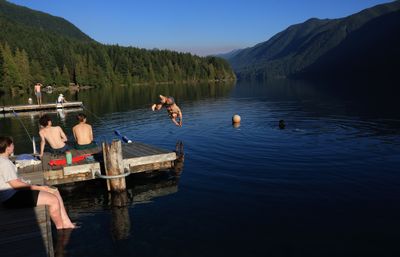 boy jumping into water