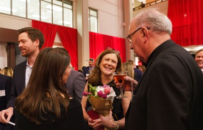 Woman laughing in the Alumni Awards reception