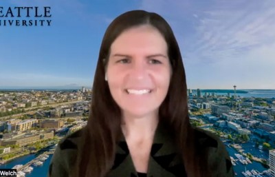 Natalie Welch smiling in front of Seattle Zoom background