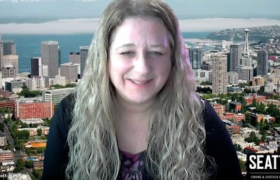 Screenshot of Dr. Helfgott in Zoom meeting smiling with Seattle background