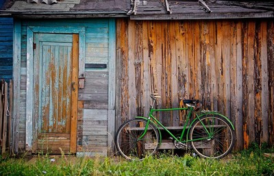 Bike stood against a shed