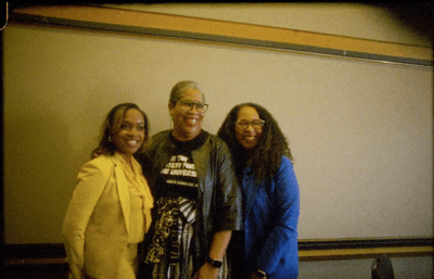 Three faculty members smiling