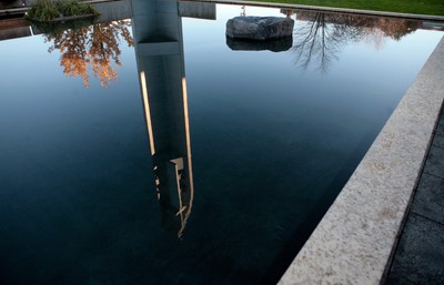 A body of water with a watchtower reflection.