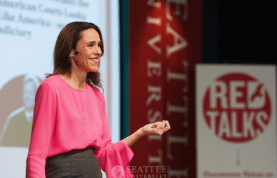 Brooke Coleman speaking on a stage.