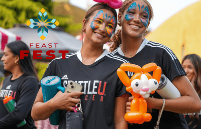 Two students with face paint, one holding a balloon animal, text reads Feast Fest