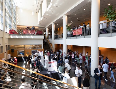 A group of people standing in a lobby.