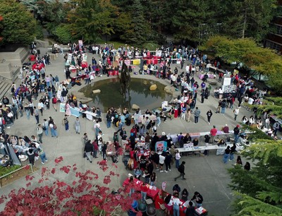 A large group of people gathered around a fountain.